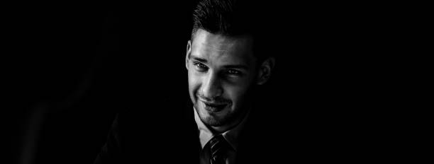 istock Man in formal business suit staring at interlocutor in shadow 1027027172