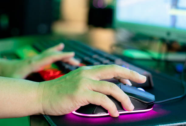 closeup of hand of man on white mouse on blue background