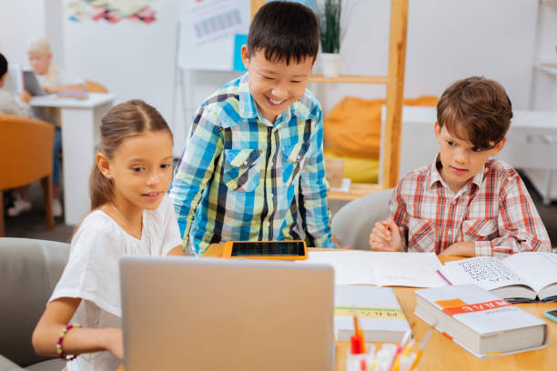 istock Smiling kids looking for the information on the Internet 1027033638