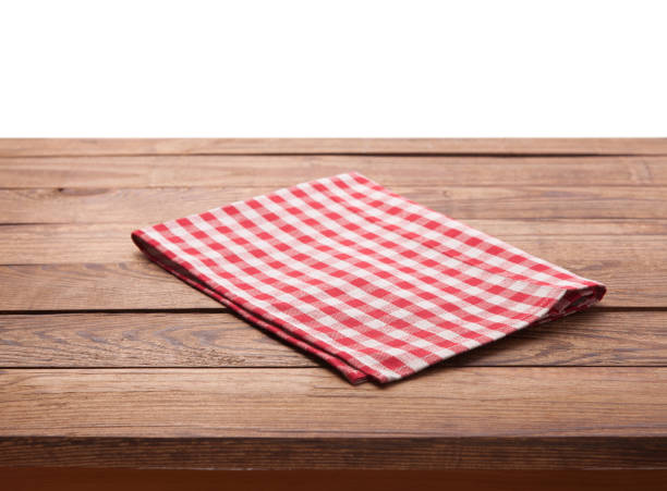 istock Red checkered tablecloth on wooden table. Napkin close up top view mock up 1027033868