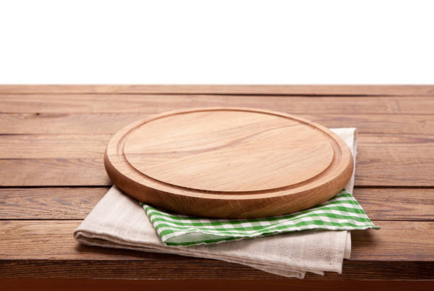 istock Board for pizza and tablecloth on wooden table isolated. Canvas, dish towels on white background top view mock up. Selective focus. 1027033874