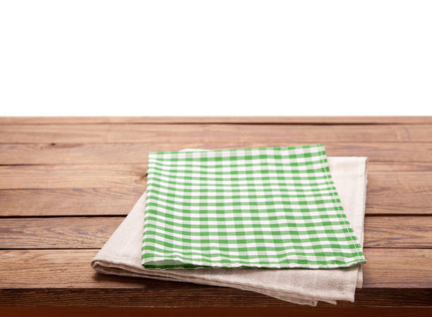 istock Tablecloth on wooden table isolated. Canvas, dish towels on kitchen top view mock up. Selective focus. 1027033876