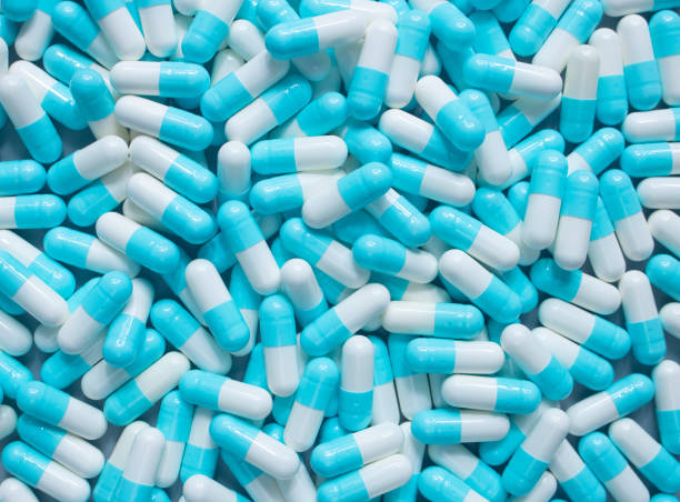 azul e branco da cápsula do medicamento droga - amoxicillin - fotografias e filmes do acervo