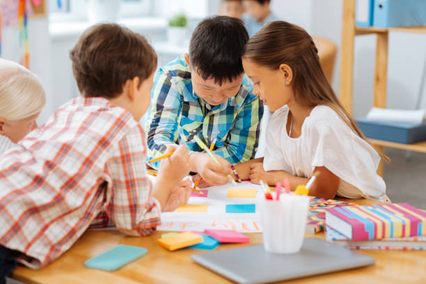 istock Creative kids drawing a nice picture in a class 1027037150