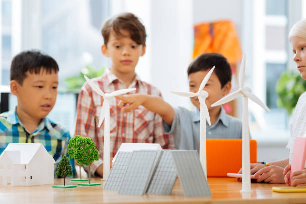 istock Cute kids making paper figures at school 1027040190