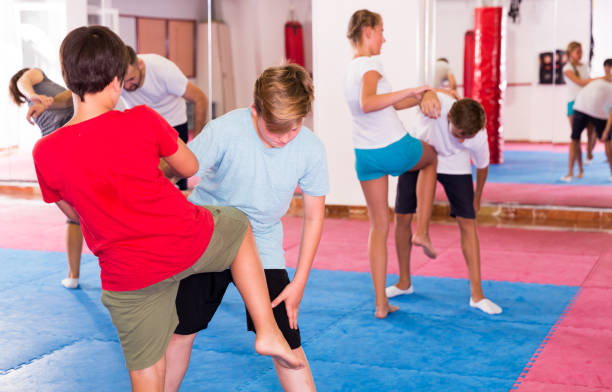 istock Kids exercising self-defense movements 1027051268