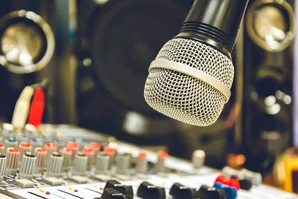 istock Sound technician control the music. The microphone is the focus. 1027052490