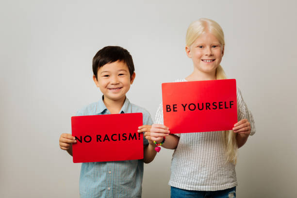 istock Smart children holding tables against racism in their hands 1027056422