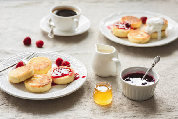 istock Breakfast Table With Curd Fritters or Pancakes, Coffee, Jam and Honey 1027056654