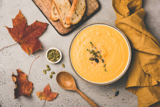istock Pumpkin cream soup in bowl on concrete background 1027056692