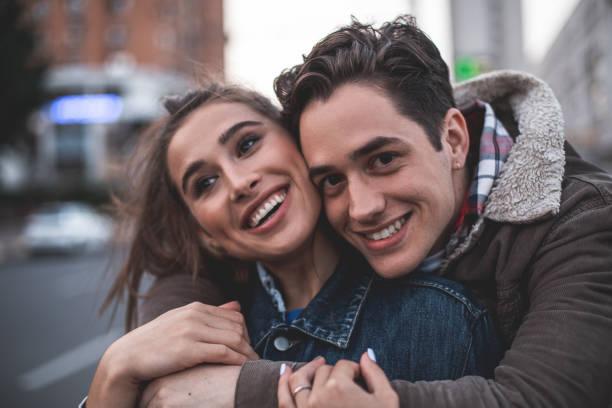 istock Happy couple embracing on street 1027058958