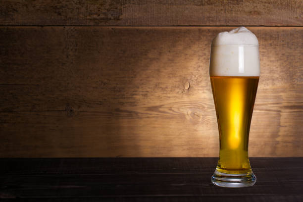istock Glass of beer on wooden background with copyspace for text 1027069032