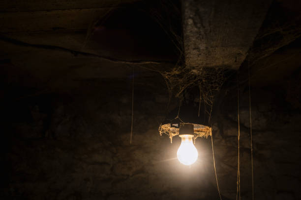 istock Light of old lamp in a creepy room with cobwebs 1027069628