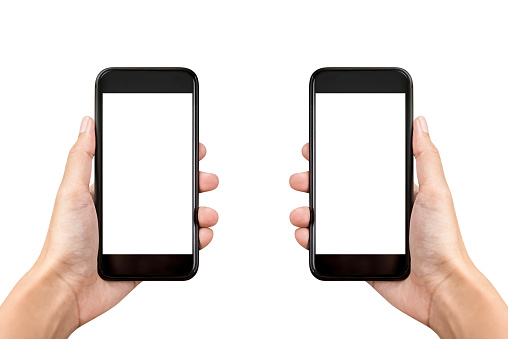 Two hands holding mobile phones on white background with empty screens for montage