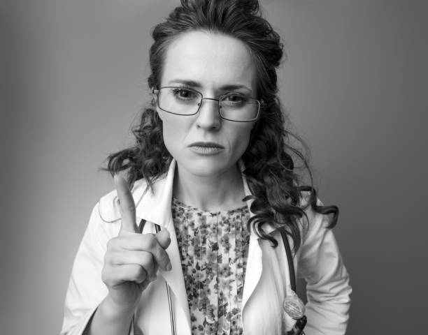 istock paediatrist doctor threatening with finger on 1027082256
