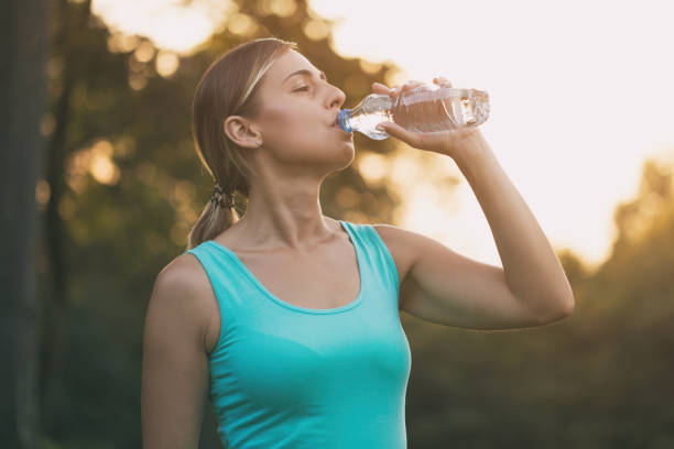 istock Woman drinking water outdoor 1027082642