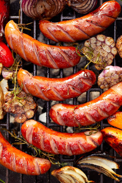 istock Grilled sausages and vegetables with addition spices and fresh herbs 1027085702