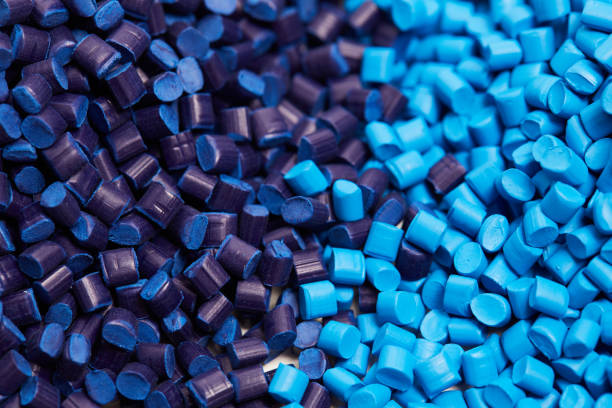 Close up of a blue plastic granules Close up of a two stacks of blue plastic polypropylene granules on a table polymer stock pictures, royalty-free photos & images