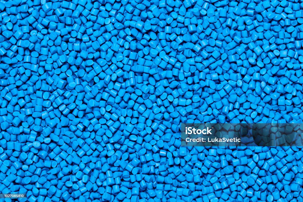 Close up of a blue plastic polypropylene granules Close up Flat lay of a blue plastic polypropylene granules on a table, copy space Plastic Stock Photo