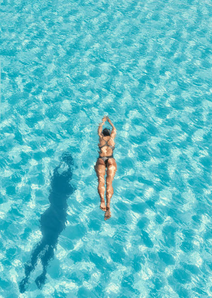 istock Woman swimming in swimming pool. 1027085972