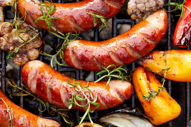 istock Grilled sausages and vegetables with addition spices and fresh herbs 1027086390