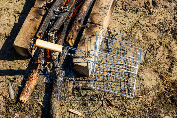 istock Barbecue grill near the campfire in a forest 1027088766