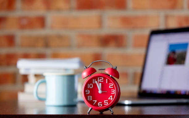 istock Little alarm clock on a table with books 1027090304