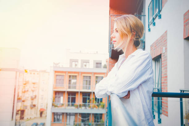 istock girl looking pensively at house 1027090324