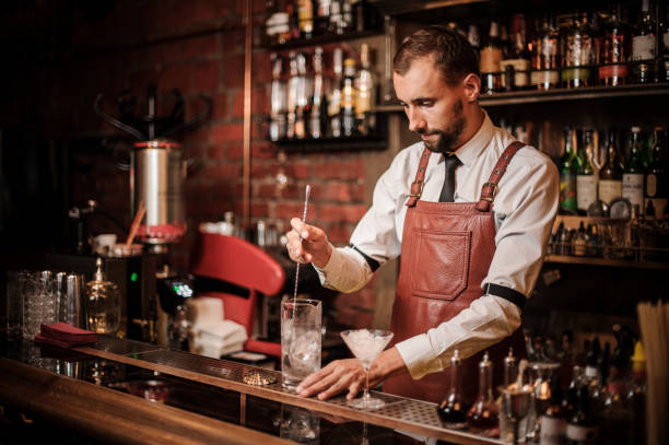 istock Bartender stirring an ice cubes in the cocktail 1027093526