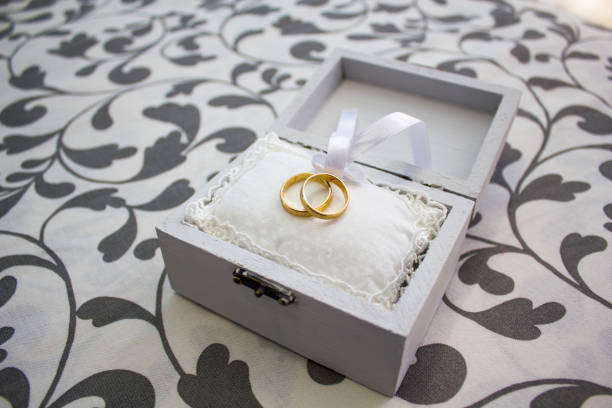 Wedding rings in a nice wooden box tied with a knot in a loop