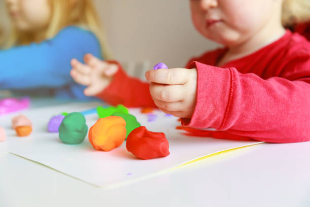 istock kids play with clay molding shapes 1027093834