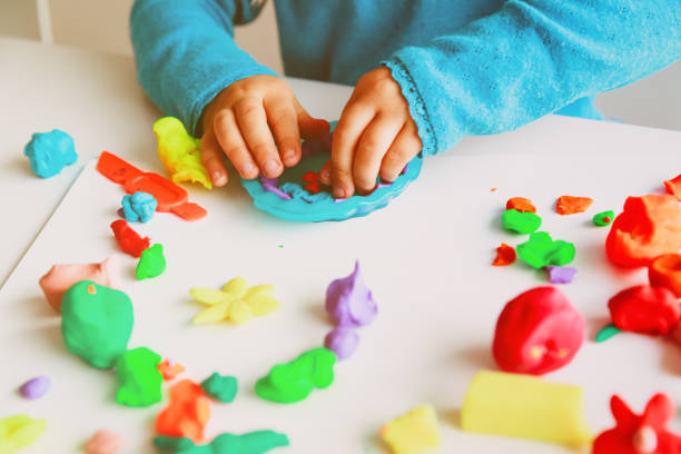 istock Child playing with clay molding shapes 1027093898