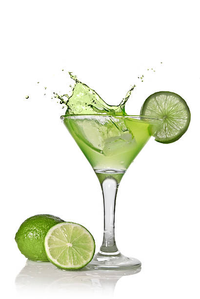 istock Green alchohol cocktail with lime and splash on white 102709593