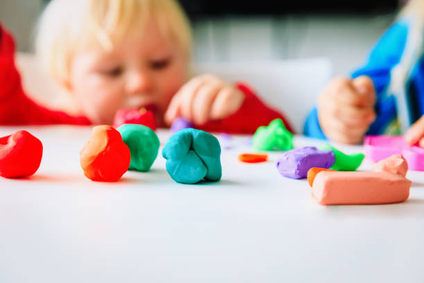 istock kids play with clay molding shapes 1027096294