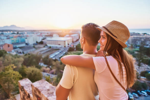 istock Happy young couple of travellers watching sunset 1027097044