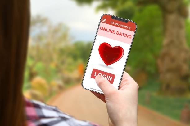 istock Online dating idea, girl with frameless phone on blurred nature background 1027100084