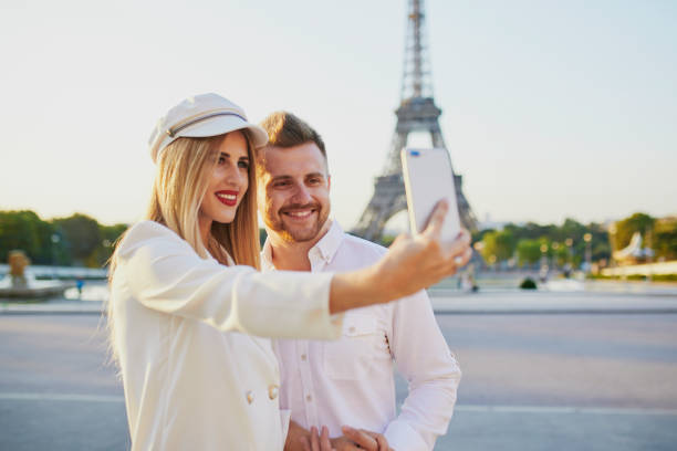 istock Happy couple taking selfie near the Eiffel tower 1027100976
