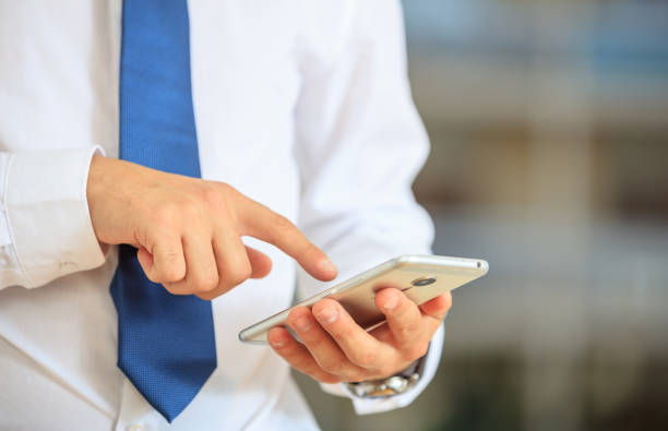 istock Businessman holding a smartphone 1027104408
