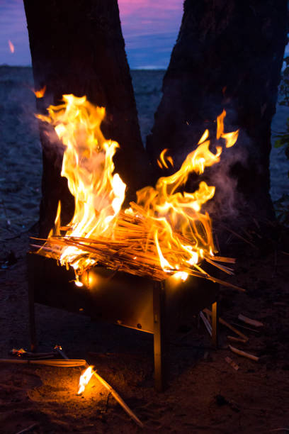 istock A divorced fire in a grill for a shish kebab. Fire at night in the grill. Bonfire at night 1027107780