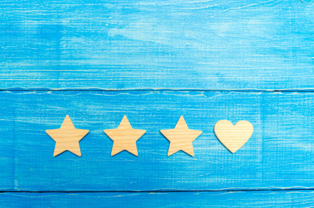 istock Three stars and a heart on a blue background. Selection of the user and clients. Universal recognition and admiration. Rating of a hotel or restaurant, commercial product or mobile application. 1027107912