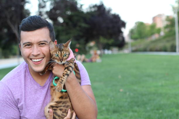 istock Handsome man in the park with his cat 1027108222