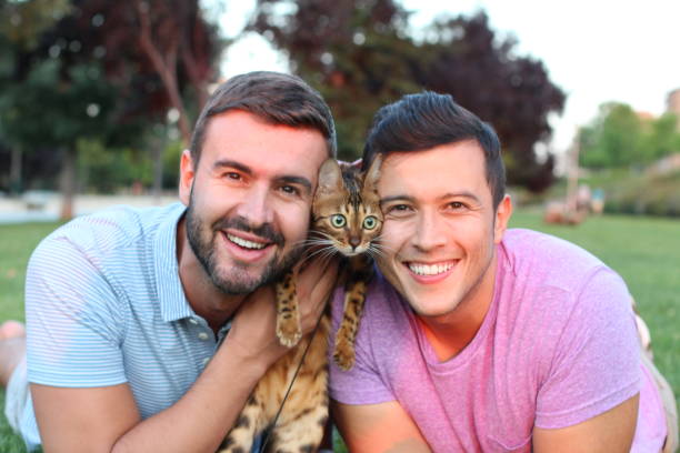 istock Cute gay couple with a bengal cat 1027108282