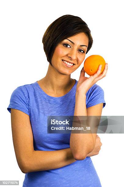 Foto de Étnico Jovem Mulher Segurando Uma Laranja e mais fotos de stock de Alimentação Saudável - Alimentação Saudável, Fundo Branco, Mulheres