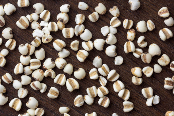 istock Millet grain on wooden table background top view 1027111360