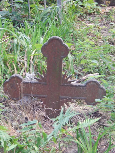 istock Crosses on graves cemetery and fences 1027129576