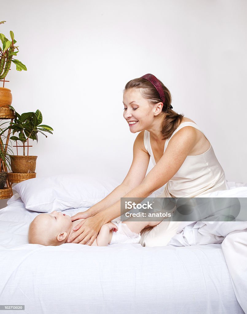 Mom and baby having a happy time Mom playing with her cute baby son Adult Stock Photo