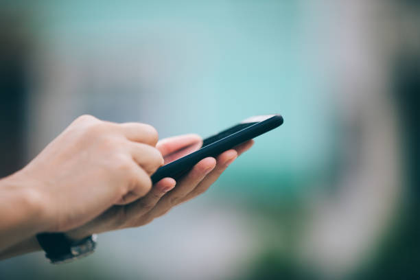 istock Hands hold smartphone take pictures in modern city 1027132390