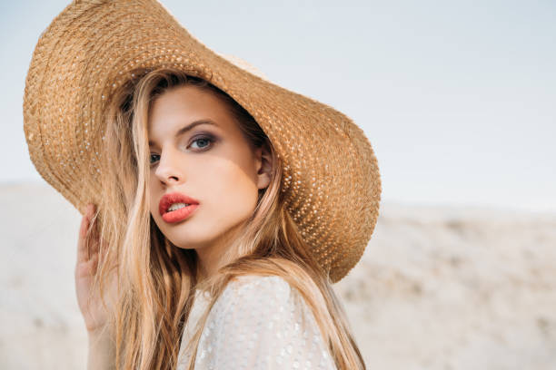 istock attractive blonde girl posing in trendy straw hat 1027136482