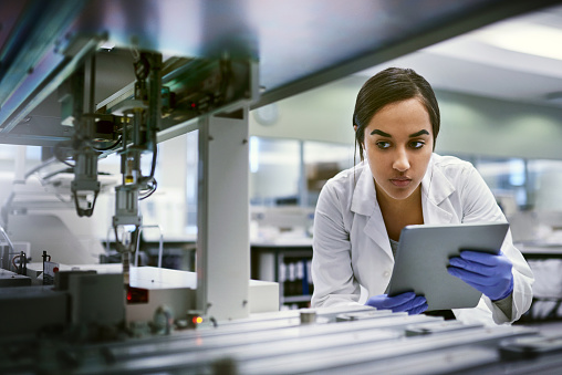 Shot of a young woman using a digital tablet while working in a laboratory