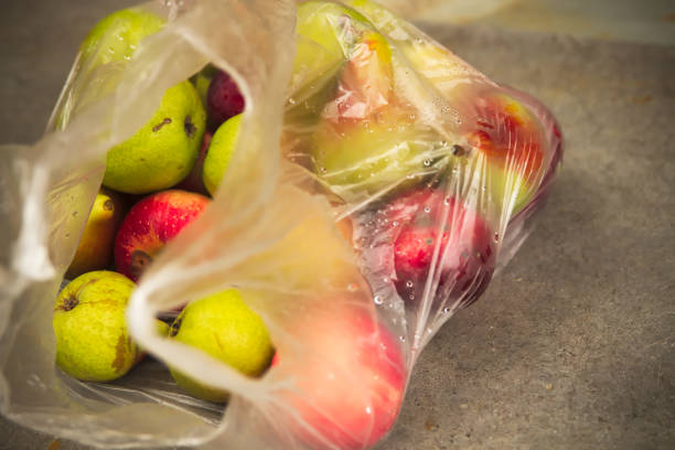 istock Fresh Domestic Apple in Transparent Bag on Table 1027140958